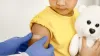 Nurse putting a plaster on a child&#039;s arm